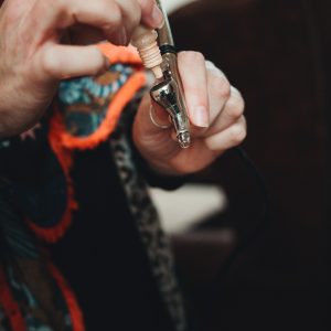 Make-up artist filling an airbrush applicator gun with foundation