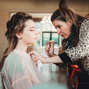 Make-up artist applying foundation using airbrush gun. Foundation is very lightly sprayed onto the skin using airbrush make-up application technology.