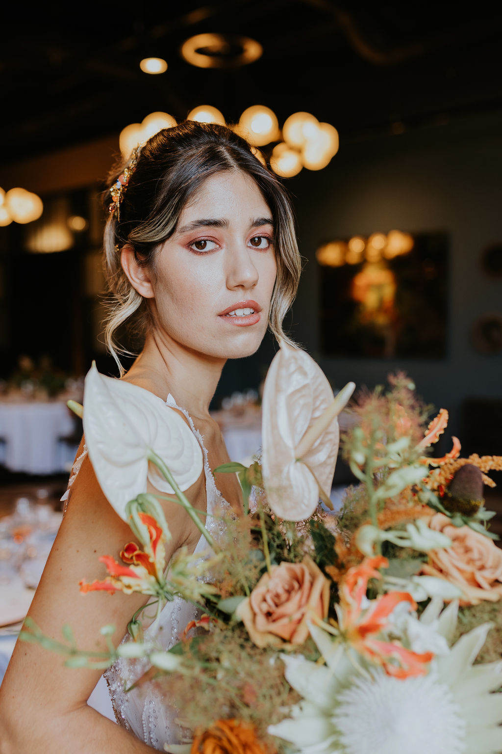 Bridal model with flawless skin, mocha-toned makeup, and a soft 90s-inspired updo with a modern twist