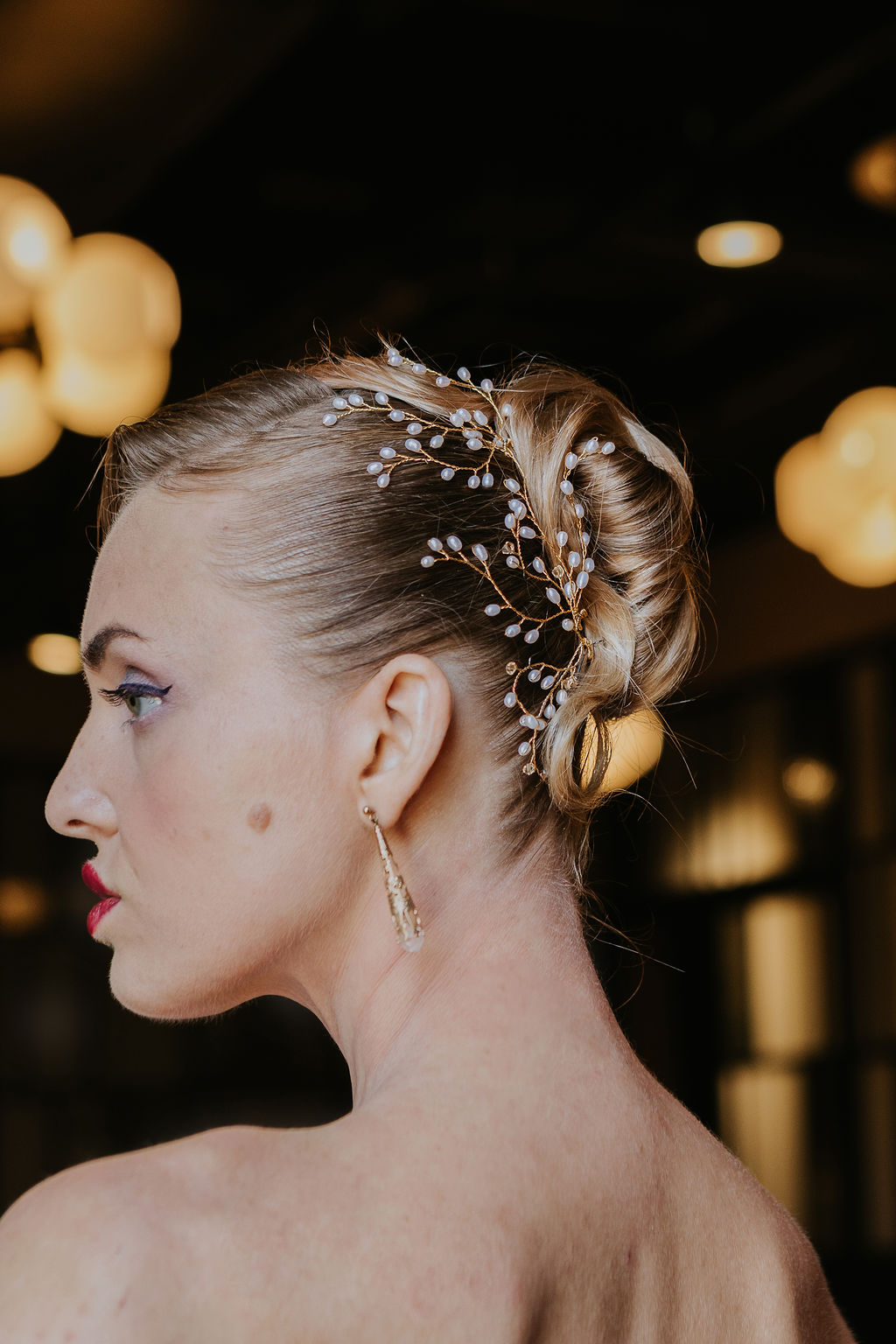 Bridal hairstyle with sculpted waves and luxury accessory, styled in a modern glam finish