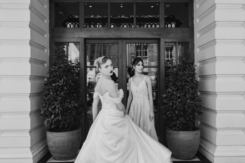Models in Madi Lane bridal gowns standing outside the Avon Gorge Hotel, showcasing modern bridal fashion against a historic Bristol backdrop